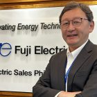Mr. Ishikawa poses in front of the Fuji Electric PH banner in this photo.